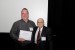 Dr. Nagib Callaos, General Chair, giving Dr. Mark Rahmes the best paper award certificate of the session "Academic / Private Sector and the ICT ." The title of the awarded paper is "Modeling Social Connections in Dynamic Ad Hoc Networks Using Layered Random Matrices."